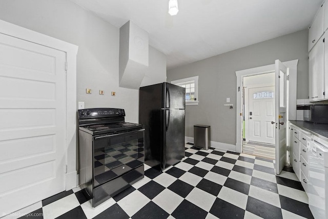711 E Illinois Ave, Spokane, WA 99207 - kitchen featuring black appliances, dark flooring, white cabinetry, and baseboards