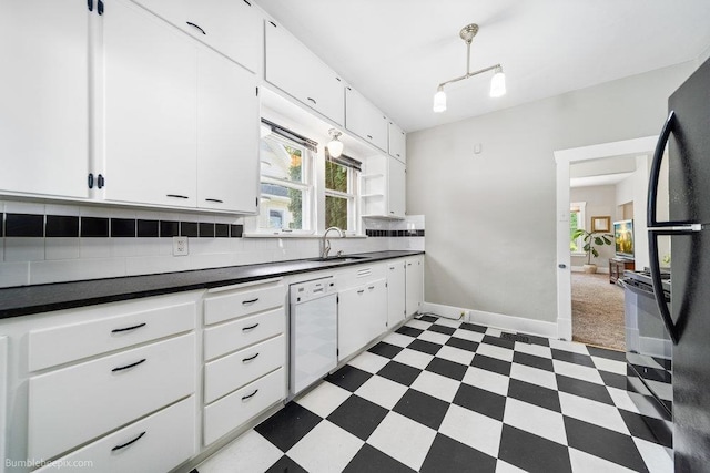 711 E Illinois Ave, Spokane, WA 99207 - kitchen with black appliances, light flooring, dark countertops, backsplash, and a sink