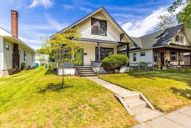 711 E Illinois Ave, Spokane, WA 99207 - view of front facade with a porch, a front lawn, and a gate