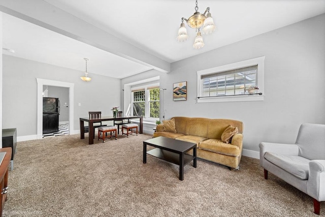 711 E Illinois Ave, Spokane, WA 99207 - carpeted living room with a chandelier, baseboards, and beam ceiling
