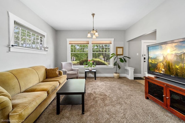 711 E Illinois Ave, Spokane, WA 99207 - living room featuring carpet flooring, a chandelier, and baseboards