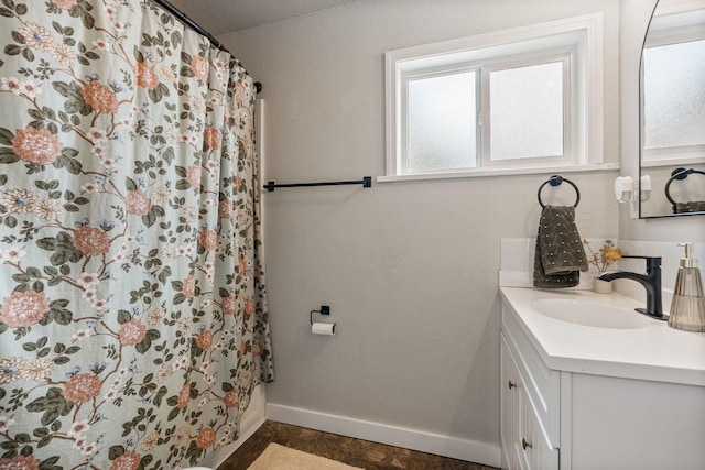 3214 E 29th Ave, Spokane, WA 99223 - bathroom featuring vanity, a shower with curtain, and baseboards