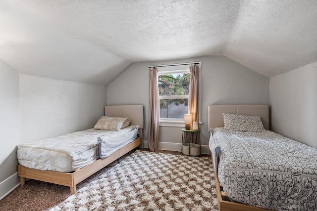 3214 E 29th Ave, Spokane, WA 99223 - bedroom featuring vaulted ceiling, carpet flooring, a textured ceiling, and baseboards