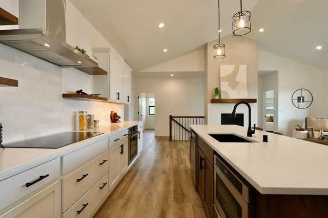 9006 E Clearview Ln, Spokane, WA 99217 - kitchen featuring ventilation hood, a sink, black appliances, open shelves, and lofted ceiling