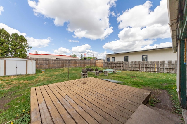 wooden terrace with a shed and an outbuilding