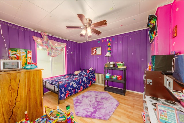 bedroom with light wood-style floors and ceiling fan