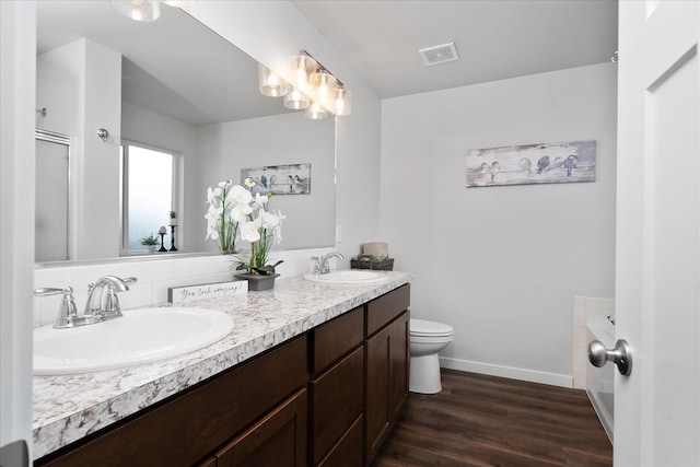 10415 W Salmonberry Rd, Cheney, WA 99004 - full bath with toilet, double vanity, wood finished floors, and baseboards