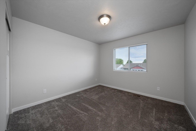 10415 W Salmonberry Rd, Cheney, WA 99004 - spare room featuring dark colored carpet and baseboards