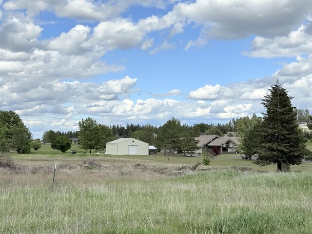 10415 W Salmonberry Rd, Cheney, WA 99004 - view of yard featuring a detached garage and an outbuilding