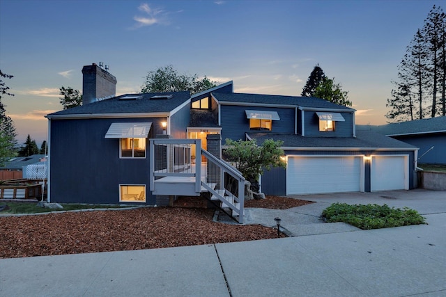 7101 N Greenwood Pl, Spokane, WA 99208 - view of front of property featuring a chimney, concrete driveway, an attached garage, and a shingled roof