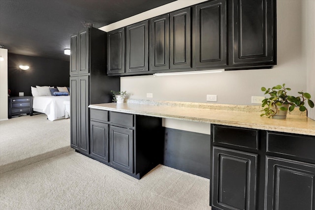 7101 N Greenwood Pl, Spokane, WA 99208 - kitchen with dark cabinets and light colored carpet