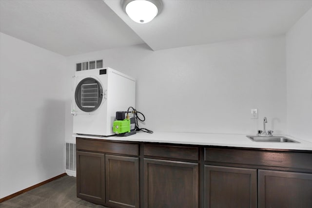 7101 N Greenwood Pl, Spokane, WA 99208 - laundry room with dark carpet, wet bar, and baseboards