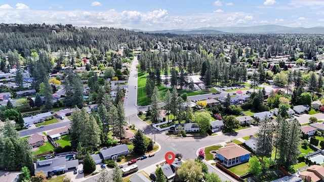 7101 N Greenwood Pl, Spokane, WA 99208 - aerial perspective of suburban area featuring a heavily wooded area and mountains