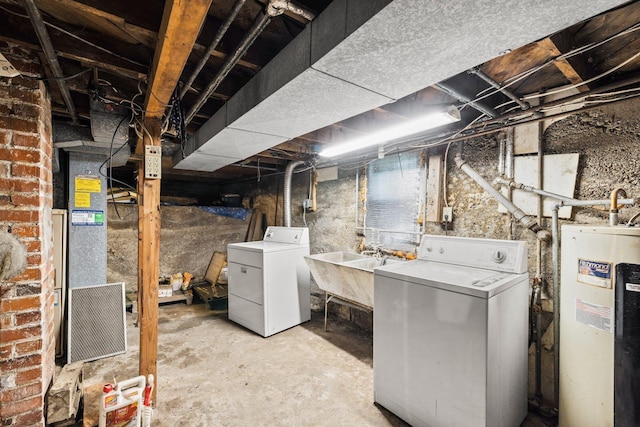 unfinished below grade area featuring electric water heater, a sink, and separate washer and dryer