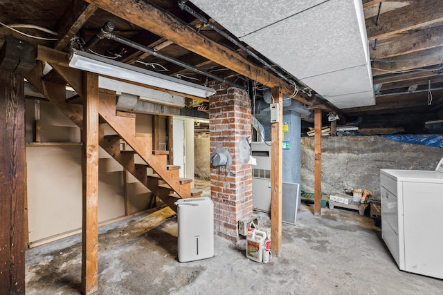 unfinished below grade area featuring washer / clothes dryer and stairway