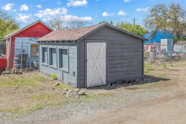 view of shed with fence