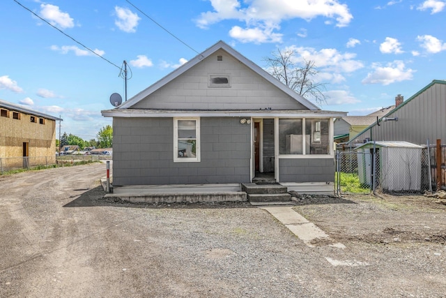 view of front of house with fence and a sunroom