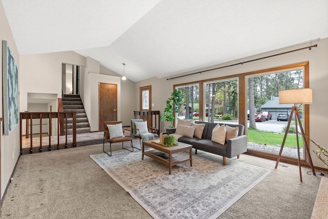 living room with carpet, stairway, and vaulted ceiling