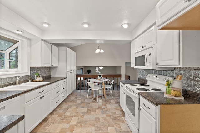 kitchen with white appliances, a sink, dark countertops, white cabinetry, and decorative backsplash