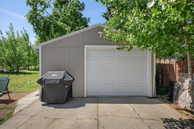 detached garage with driveway and fence
