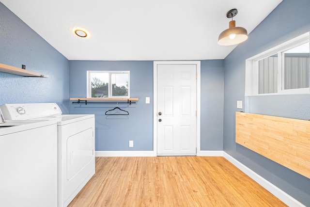 1653 E Ostrander Ave, Spokane, WA 99207 - laundry area with washer and clothes dryer, light wood-style floors, baseboards, and a textured wall