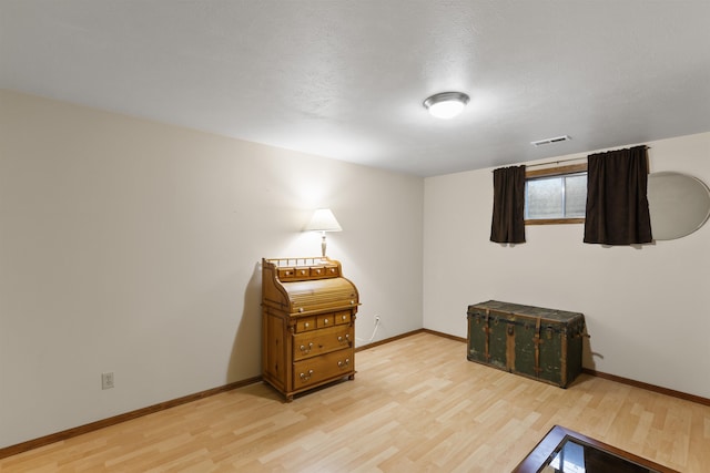 bedroom with light wood-style floors and baseboards