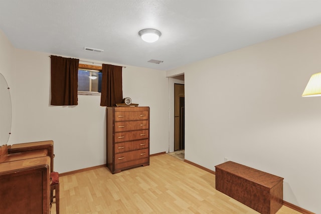 bedroom with light wood-style floors and baseboards