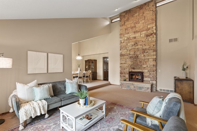 carpeted living room featuring high vaulted ceiling and a fireplace