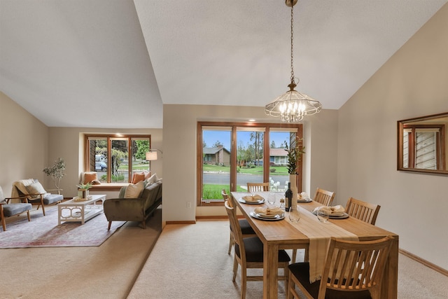 dining room featuring light colored carpet, a chandelier, vaulted ceiling, and baseboards