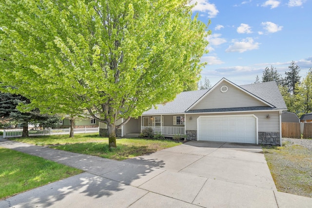 2450 E Black Forest Ave, Post Falls, ID 83854 - view of front of house with stone siding, an attached garage, driveway, and roof with shingles