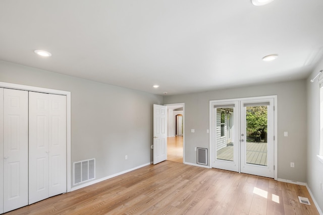 2450 E Black Forest Ave, Post Falls, ID 83854 - unfurnished bedroom with access to exterior, light wood-type flooring, recessed lighting, and baseboards
