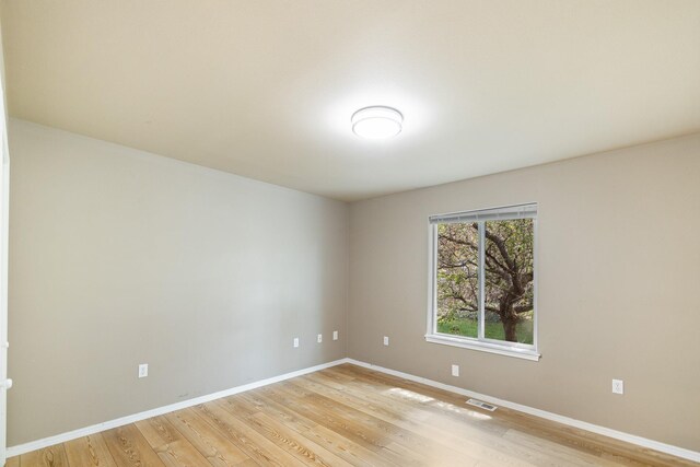 2450 E Black Forest Ave, Post Falls, ID 83854 - empty room featuring light wood-style flooring and baseboards