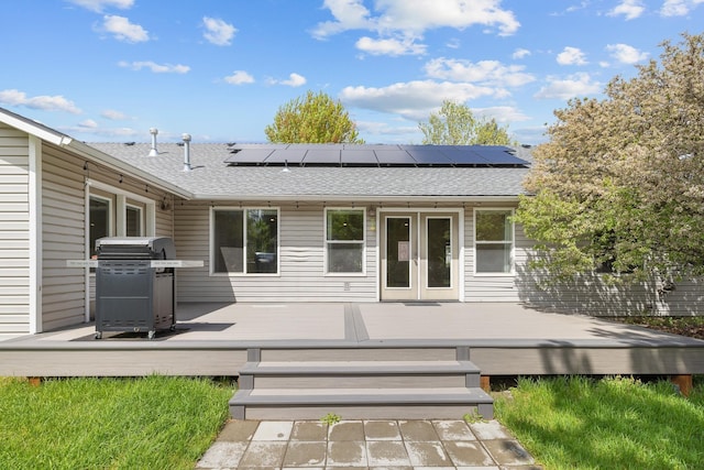 2450 E Black Forest Ave, Post Falls, ID 83854 - back of property with roof with shingles, french doors, roof mounted solar panels, and a deck