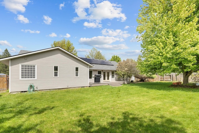 2450 E Black Forest Ave, Post Falls, ID 83854 - back of property featuring solar panels and french doors