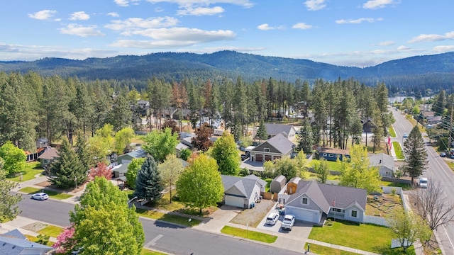2450 E Black Forest Ave, Post Falls, ID 83854 - aerial perspective of suburban area with a mountain backdrop and a forest