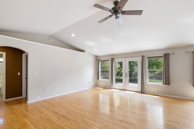 2450 E Black Forest Ave, Post Falls, ID 83854 - spare room with arched walkways, lofted ceiling, light wood-style flooring, french doors, and a ceiling fan