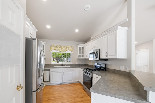 2450 E Black Forest Ave, Post Falls, ID 83854 - kitchen featuring appliances with stainless steel finishes, a sink, a peninsula, white cabinetry, and recessed lighting