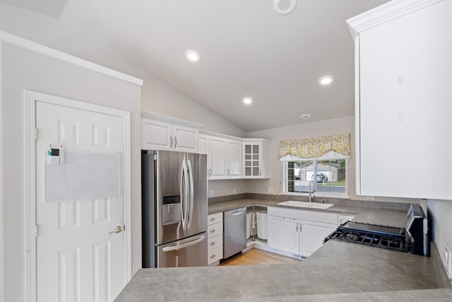 2450 E Black Forest Ave, Post Falls, ID 83854 - kitchen with appliances with stainless steel finishes, a sink, vaulted ceiling, white cabinets, and recessed lighting
