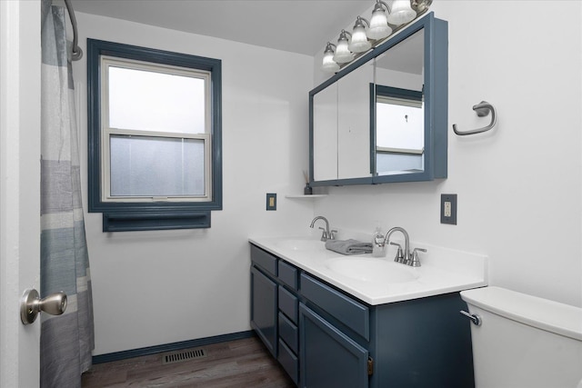 2623 W Olympic Ave, Spokane, WA 99205 - bathroom featuring double vanity and wood finished floors