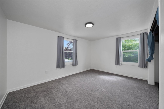 2623 W Olympic Ave, Spokane, WA 99205 - empty room featuring dark colored carpet and baseboards