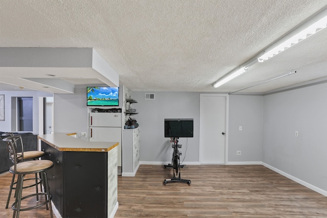1007 S Bowdish Rd, Spokane Valley, WA 99206 - indoor dry bar with wood finished floors, a textured ceiling, baseboards, and freestanding refrigerator