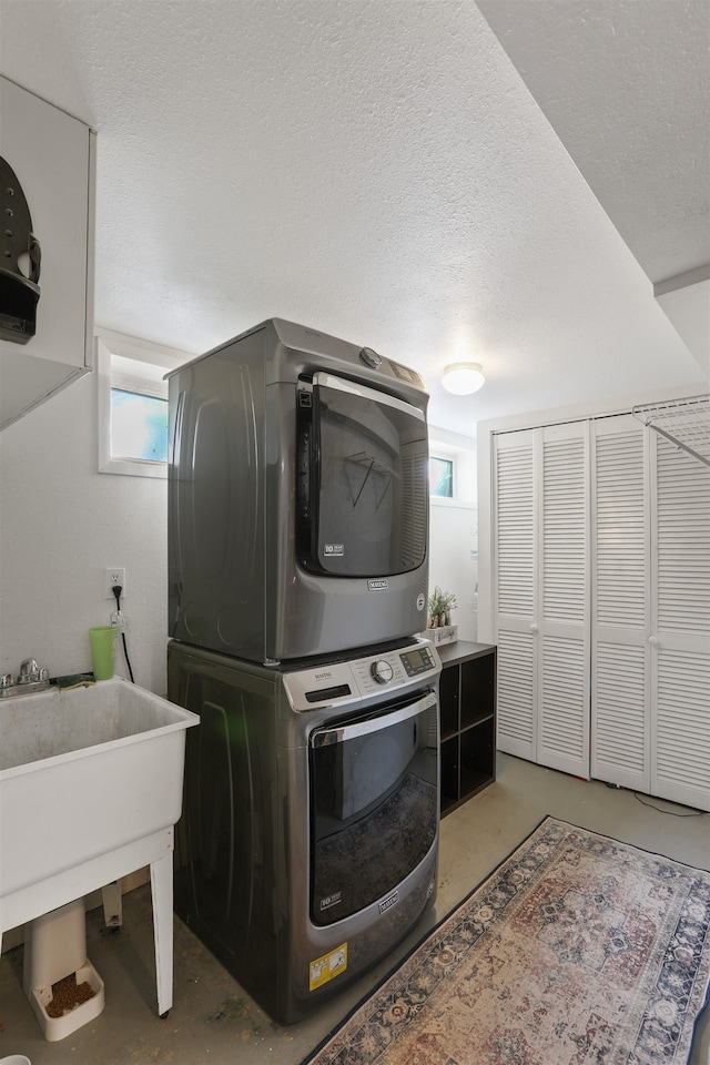 1007 S Bowdish Rd, Spokane Valley, WA 99206 - laundry room featuring estacked washer and dryer and a textured ceiling