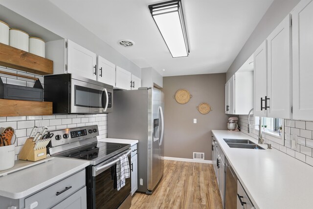 1007 S Bowdish Rd, Spokane Valley, WA 99206 - kitchen with appliances with stainless steel finishes, a sink, baseboards, and decorative backsplash