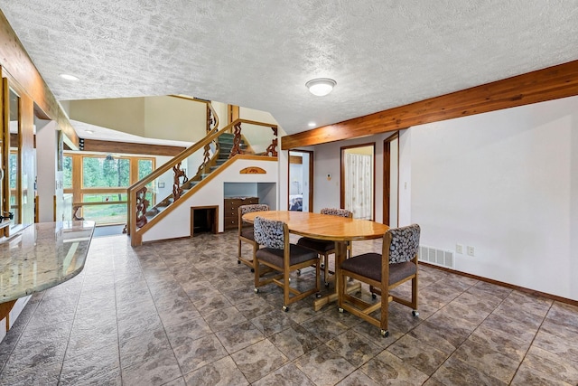 16615 W Stoughton Rd, Cheney, WA 99004 - dining room featuring stairs, baseboards, and a textured ceiling