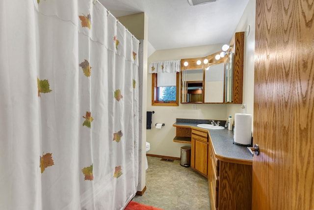 16615 W Stoughton Rd, Cheney, WA 99004 - bathroom featuring toilet, vanity, baseboards, and curtained shower