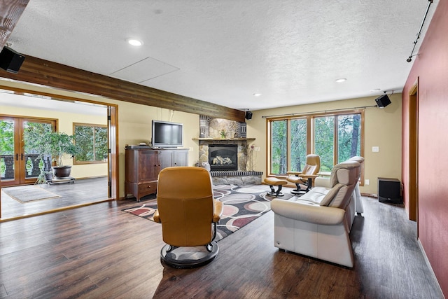 16615 W Stoughton Rd, Cheney, WA 99004 - living area with a textured ceiling, wood finished floors, a stone fireplace, recessed lighting, and french doors