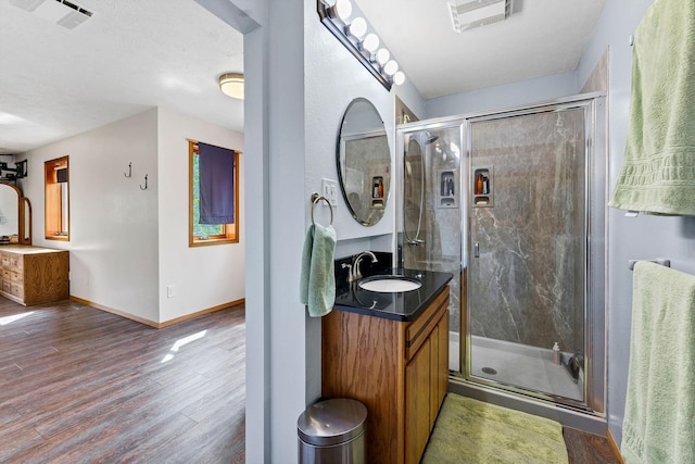 16615 W Stoughton Rd, Cheney, WA 99004 - full bathroom featuring vanity, wood finished floors, a shower stall, and baseboards