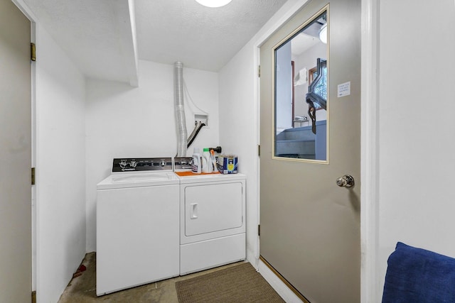 16615 W Stoughton Rd, Cheney, WA 99004 - laundry room featuring washing machine and dryer and a textured ceiling