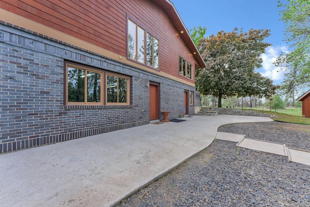 16615 W Stoughton Rd, Cheney, WA 99004 - view of property exterior with brick siding and a patio area