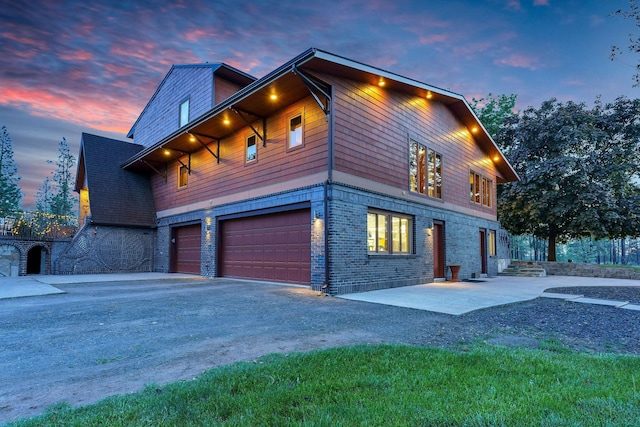 16615 W Stoughton Rd, Cheney, WA 99004 - view of side of home with a garage, asphalt driveway, and brick siding